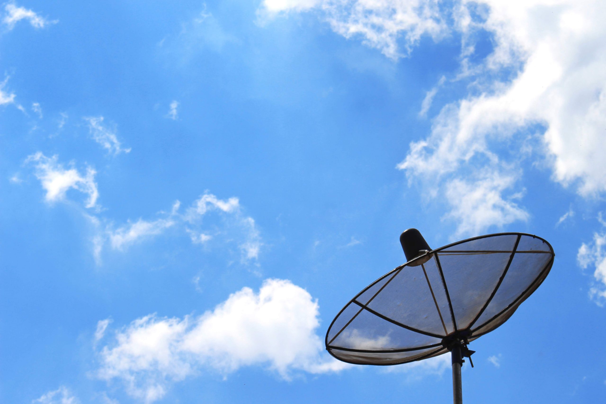 Satellite dish on the background of clouds and-sky